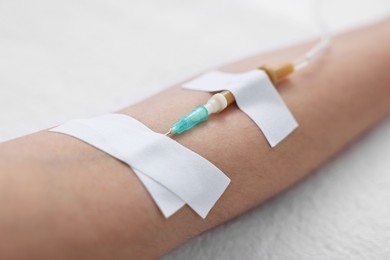 Woman with intravenous drip in hospital bed, closeup