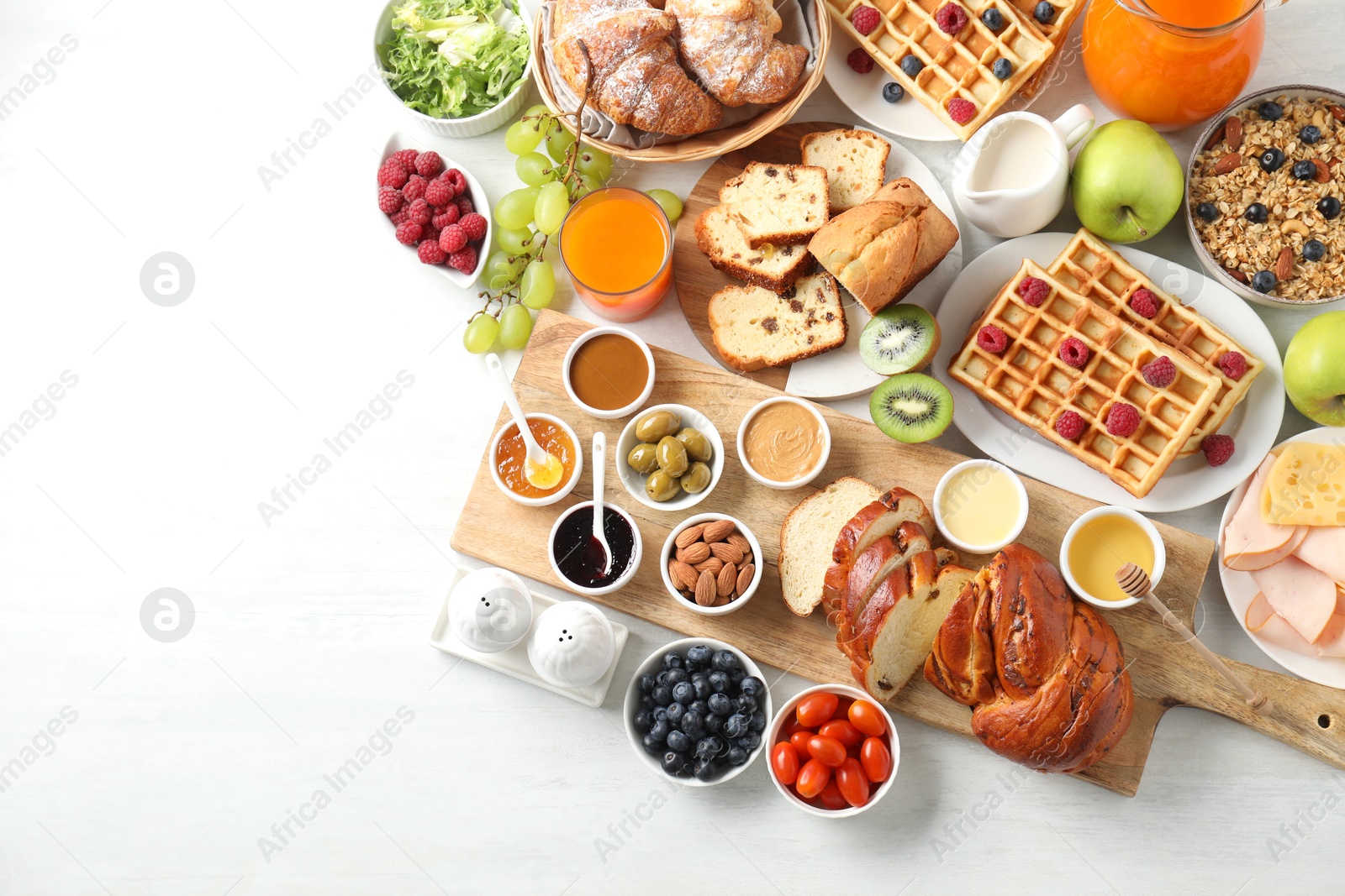 Photo of Different meals served for breakfast on white table, flat lay