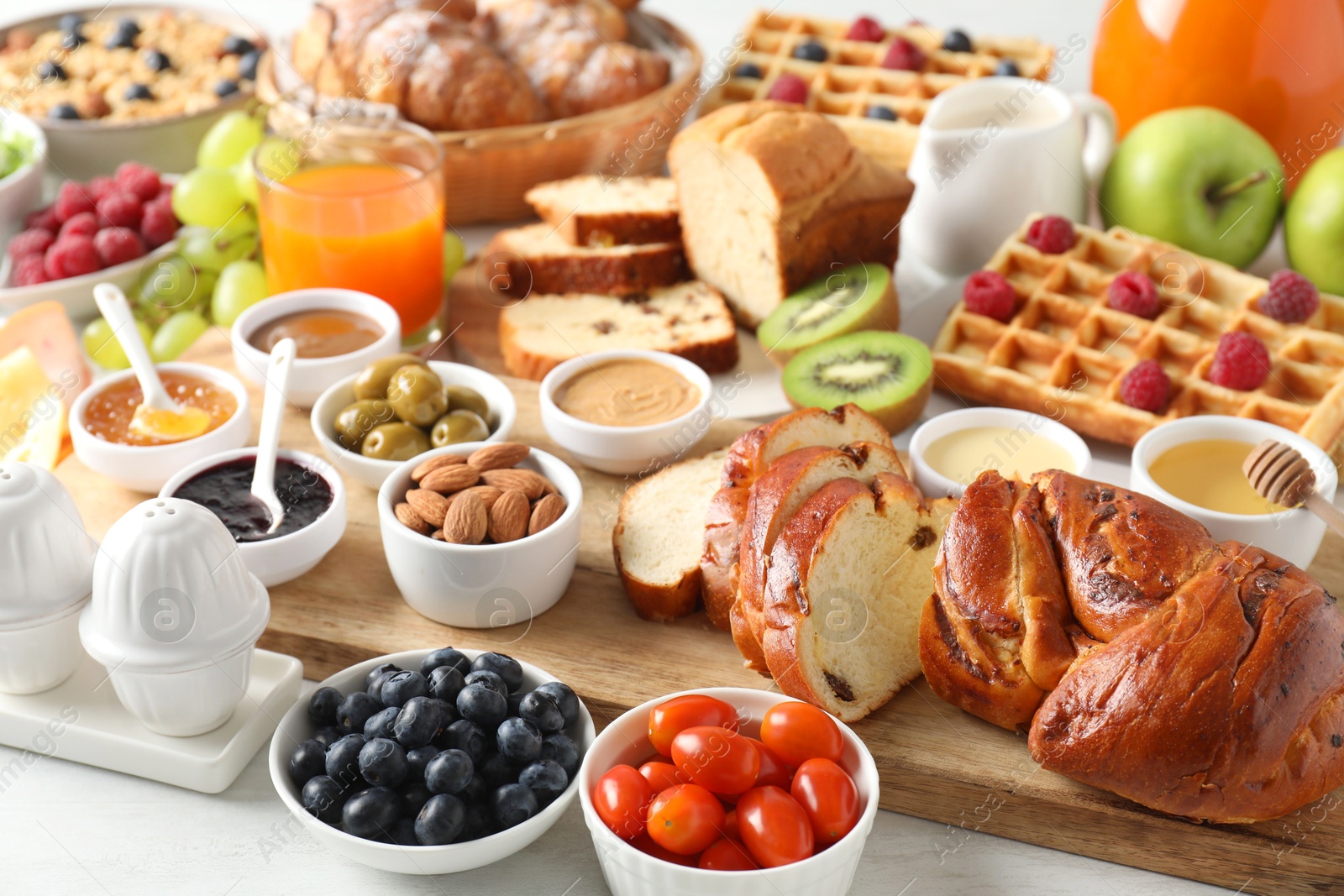 Photo of Different meals served for breakfast on white table