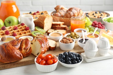 Photo of Different meals served for breakfast on white table