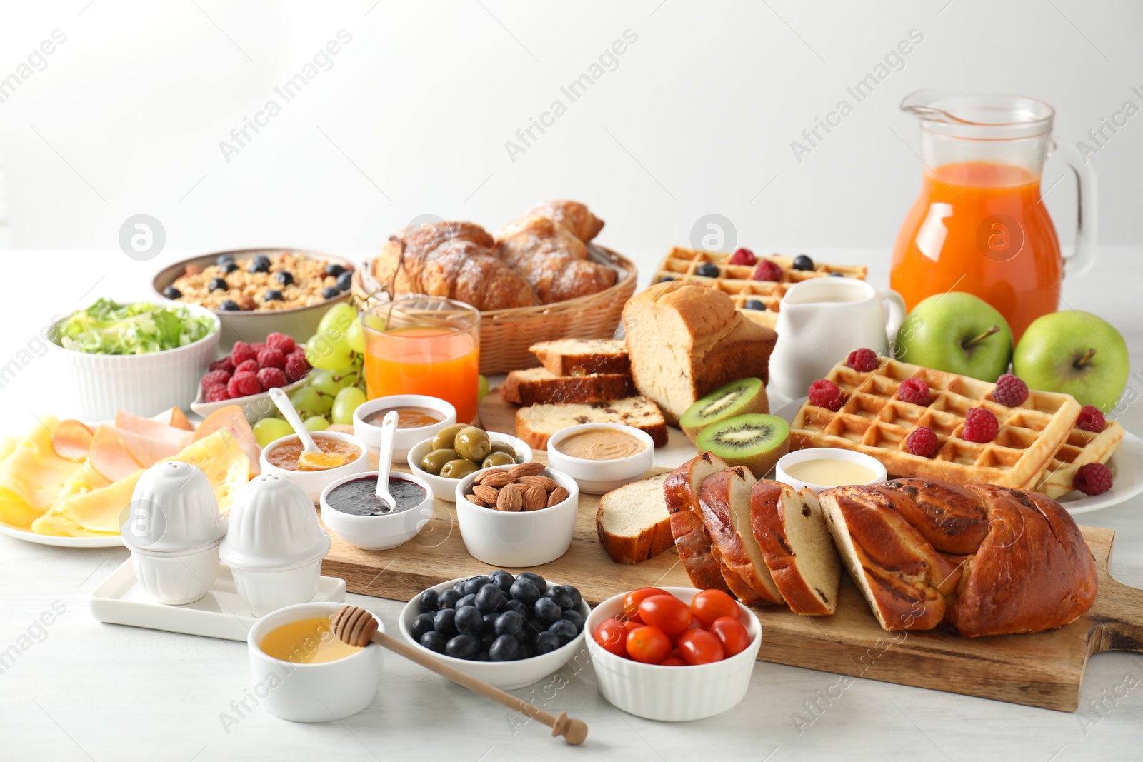 Photo of Different meals served for breakfast on white table