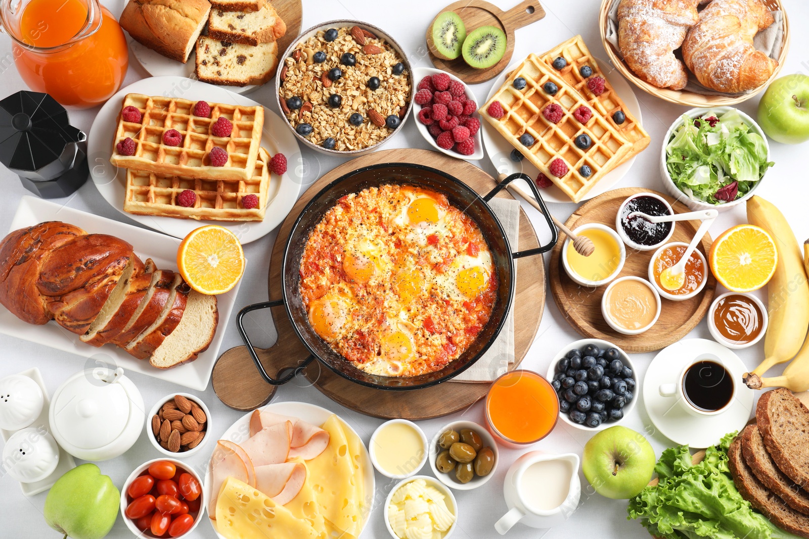 Photo of Different meals served for breakfast on white table, flat lay