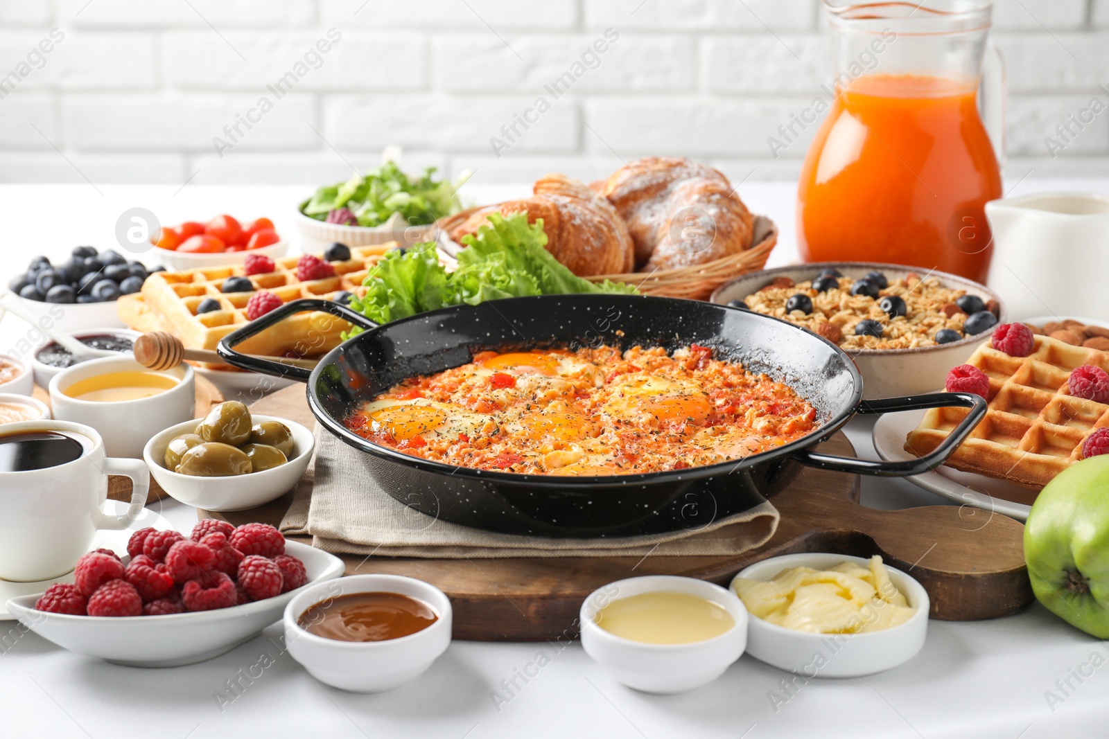 Photo of Different meals served for breakfast on white table