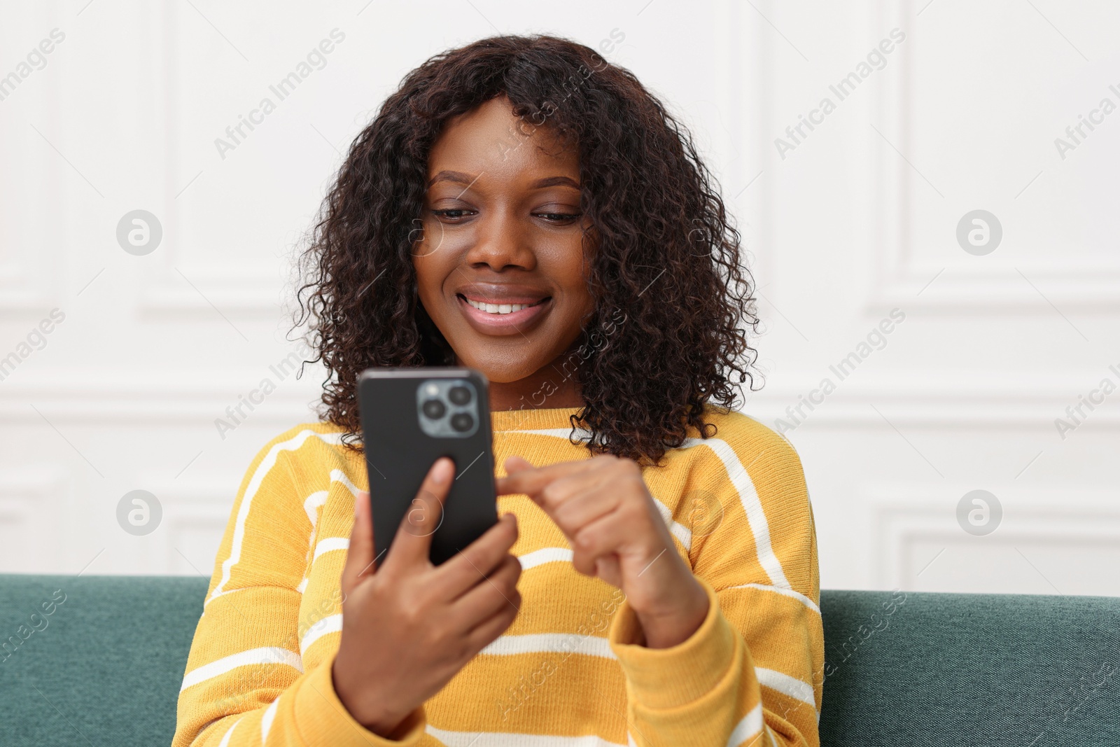 Photo of Beautiful woman using mobile phone at home