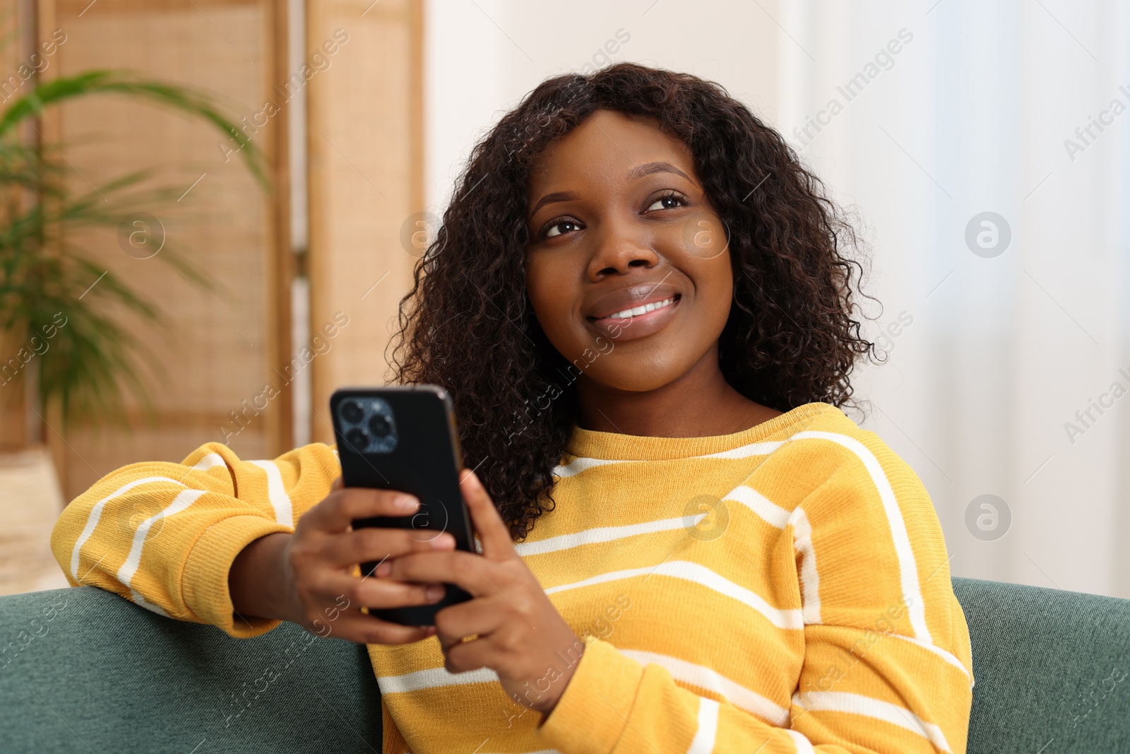 Photo of Beautiful woman with mobile phone at home