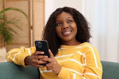 Beautiful woman with mobile phone at home