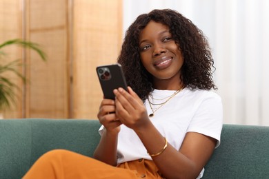 Beautiful woman with mobile phone at home