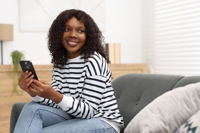 Photo of Beautiful woman with mobile phone at home