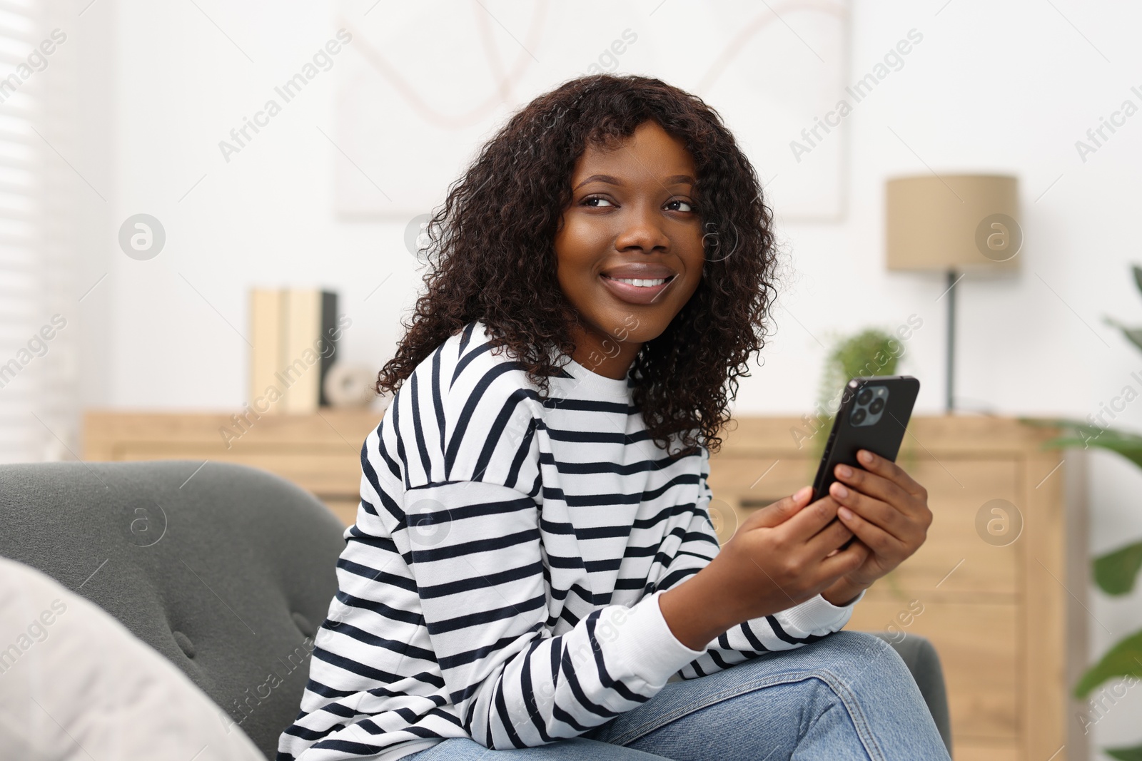 Photo of Beautiful woman with mobile phone at home