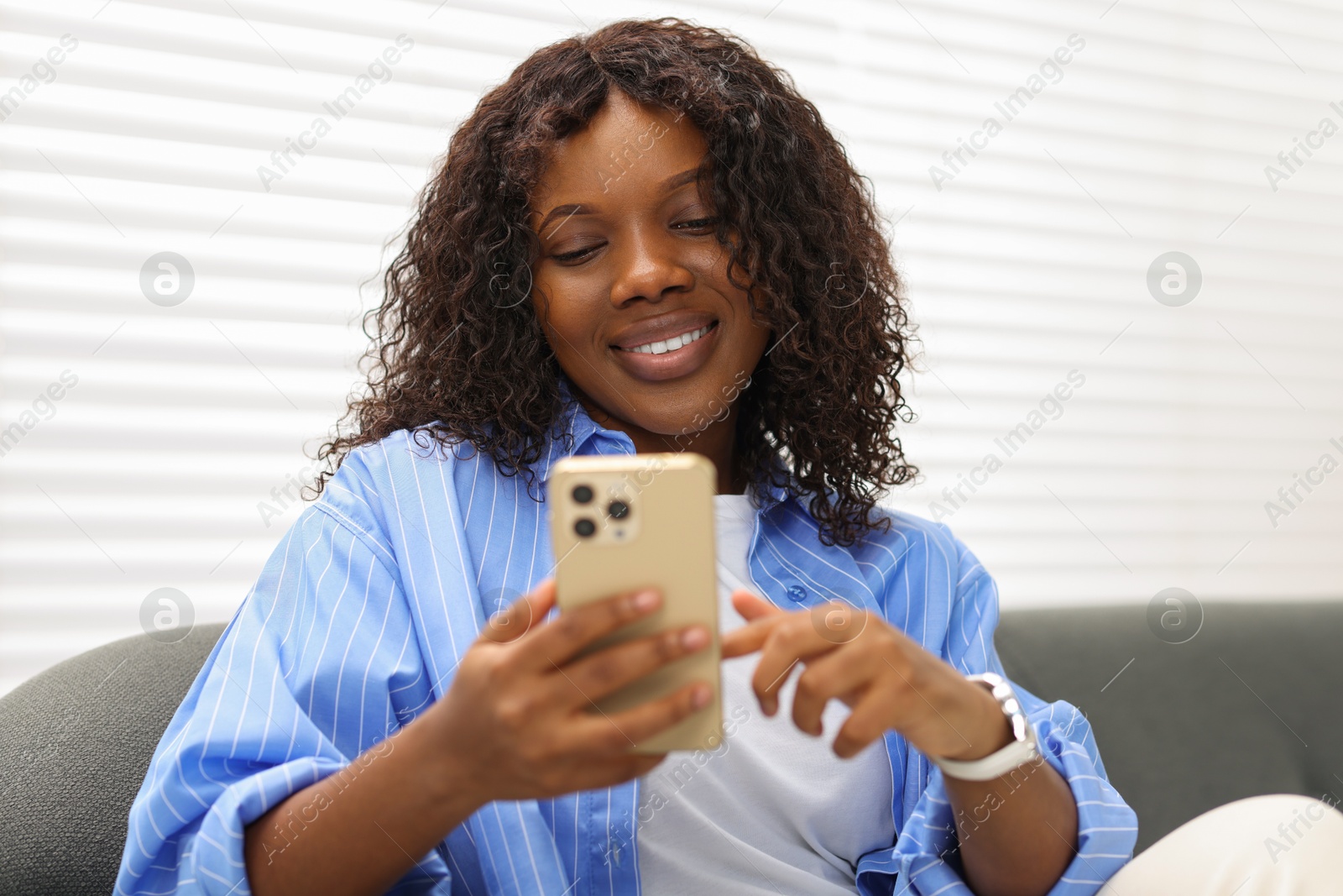 Photo of Beautiful woman using mobile phone at home