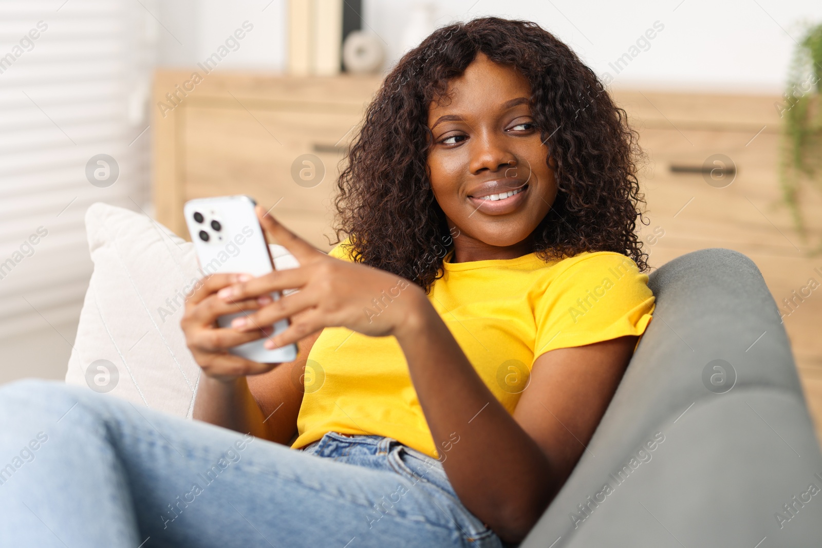 Photo of Beautiful woman with mobile phone at home