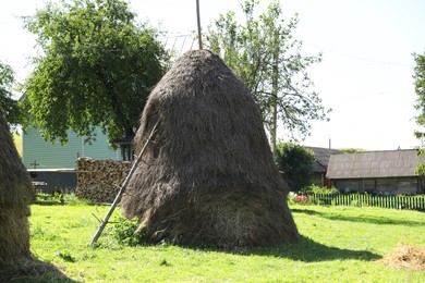 Photo of Pile of hay on farmland on sunny day