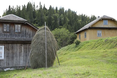 Pile of hay near barn on farmland