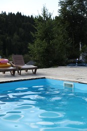 Photo of Outdoor swimming pool and sunbeds in luxury hotel