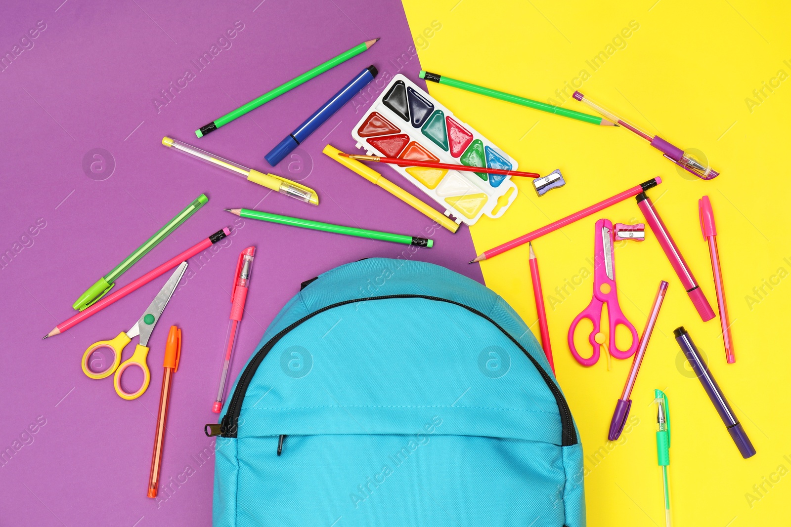 Photo of Flat lay composition with backpack and different school stationery on color background