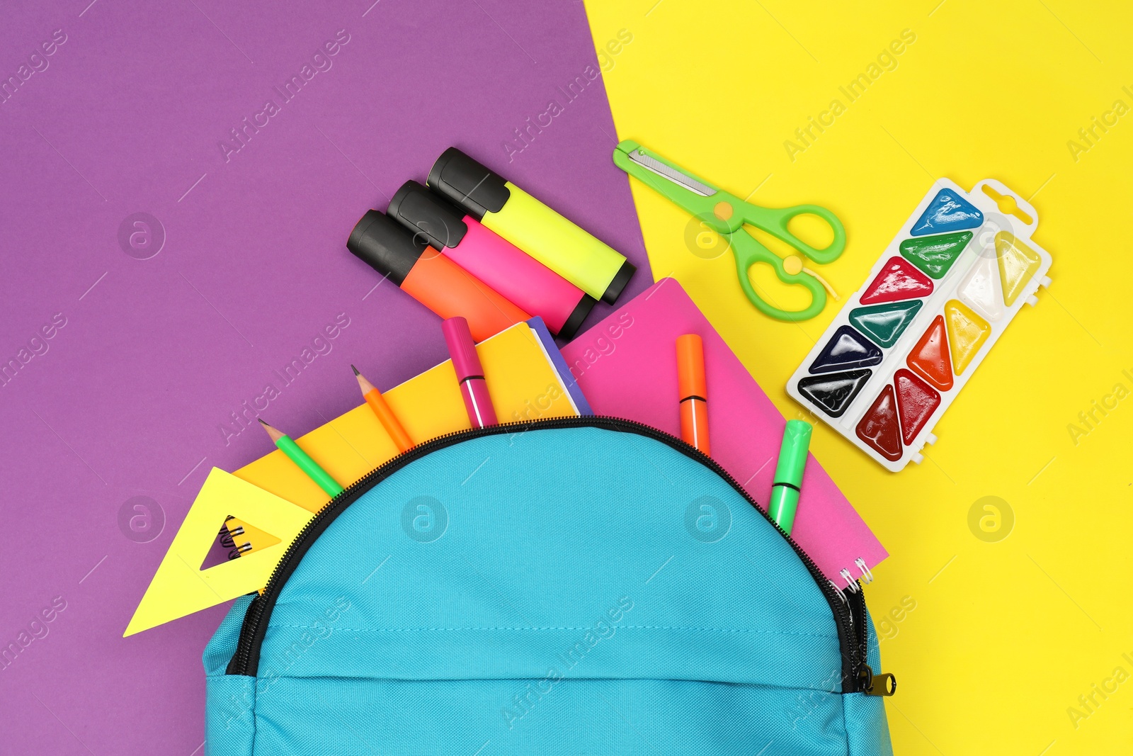 Photo of Flat lay composition with backpack and different school stationery on color background