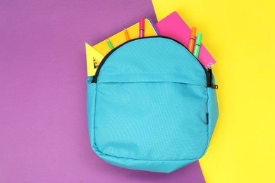 Photo of Backpack and different school stationery on color background, top view