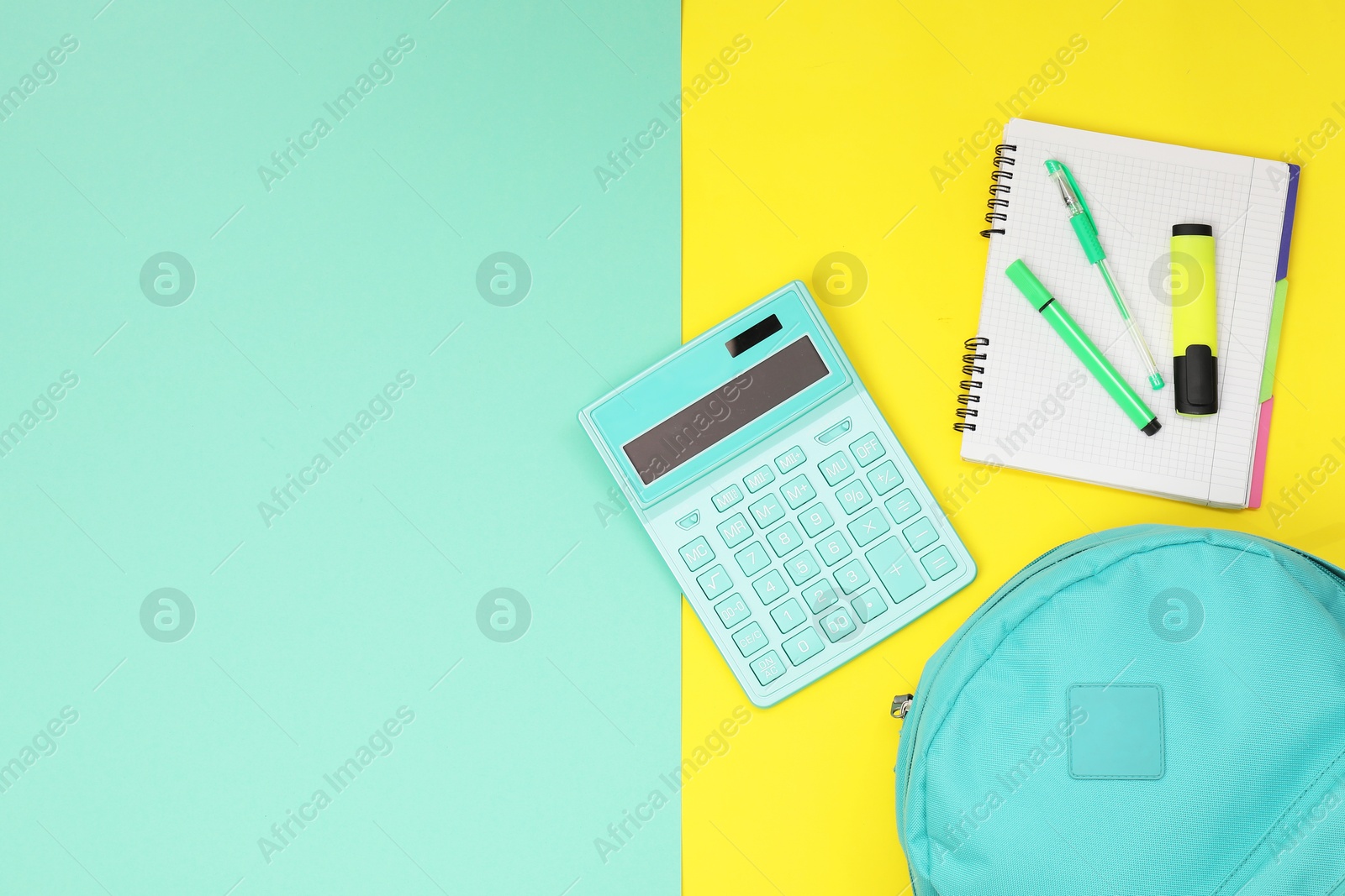 Photo of Flat lay composition with backpack and different school stationery on color background, space for text