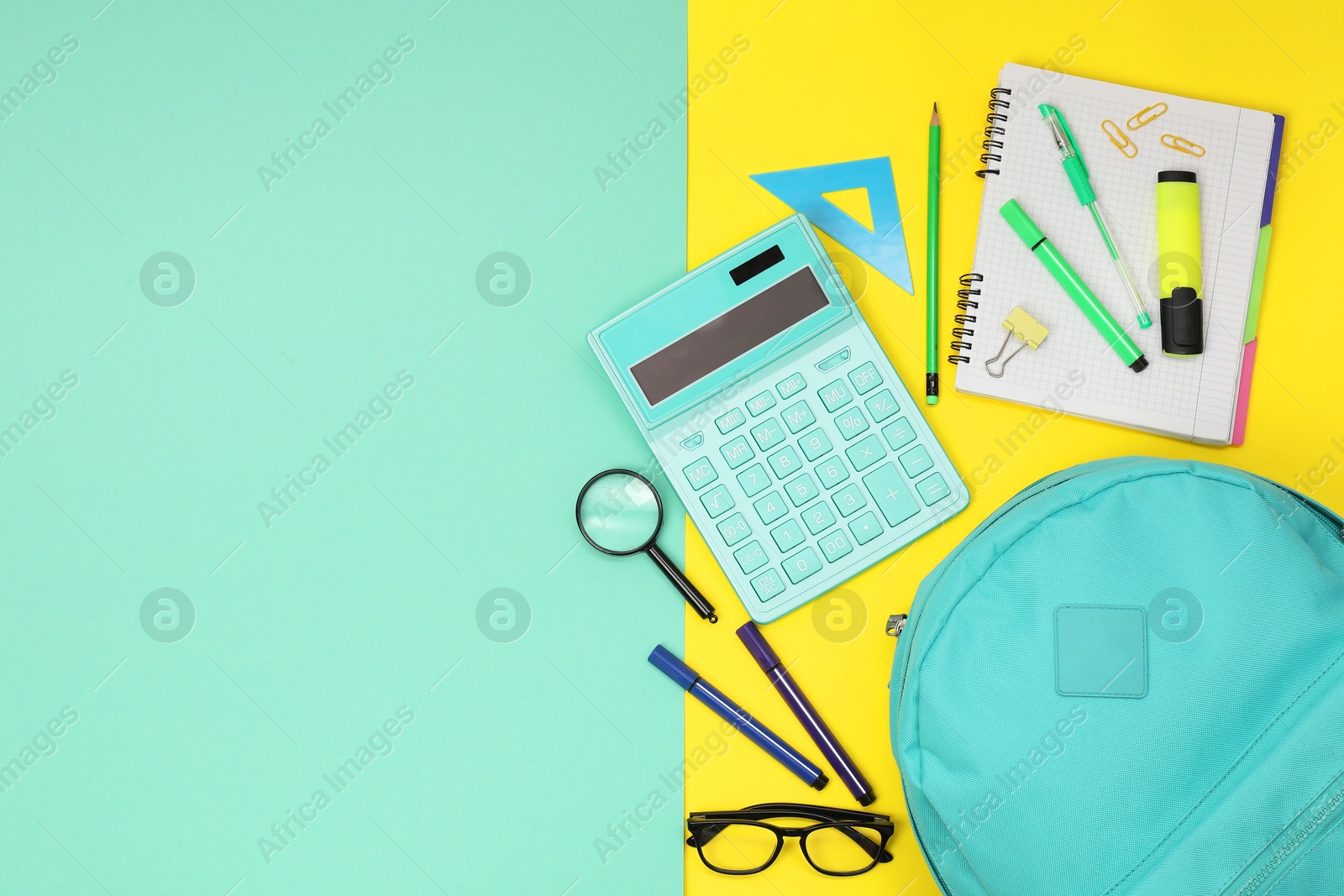 Photo of Flat lay composition with backpack and different school stationery on color background, space for text