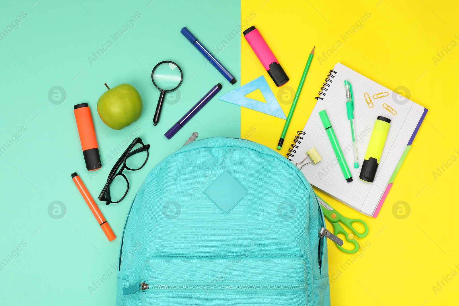 Photo of Flat lay composition with backpack and different school stationery on color background