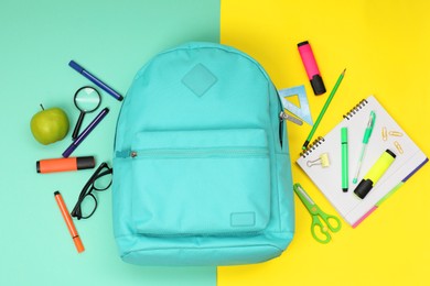 Photo of Flat lay composition with backpack and different school stationery on color background