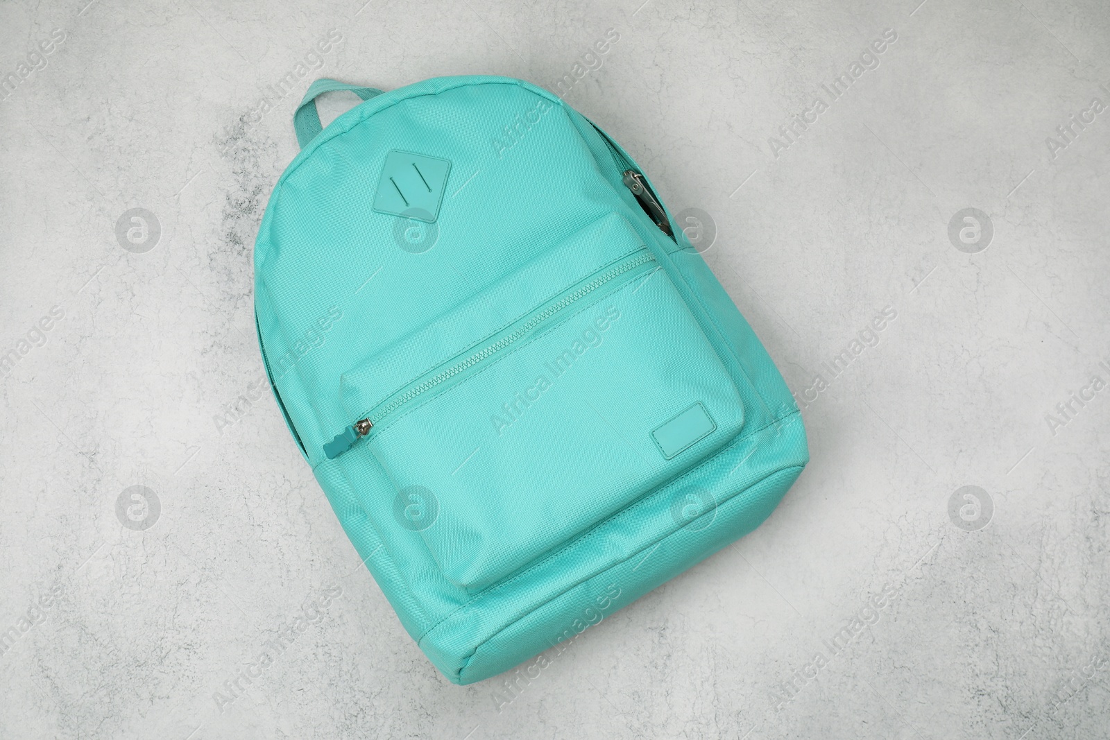 Photo of Turquoise school backpack on light grey table, top view