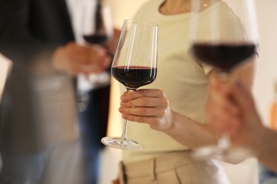 Photo of Friends with glasses of red wine, selective focus