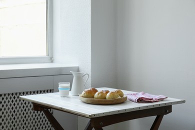 Photo of Buns and milk on table in studio. Professional food photography