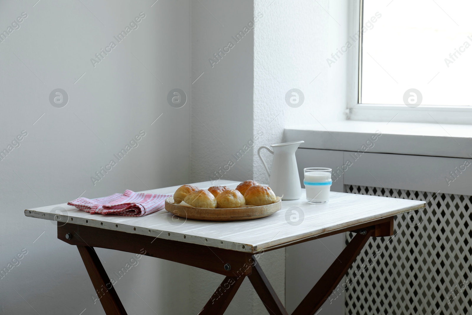 Photo of Buns and milk on table in studio. Professional food photography