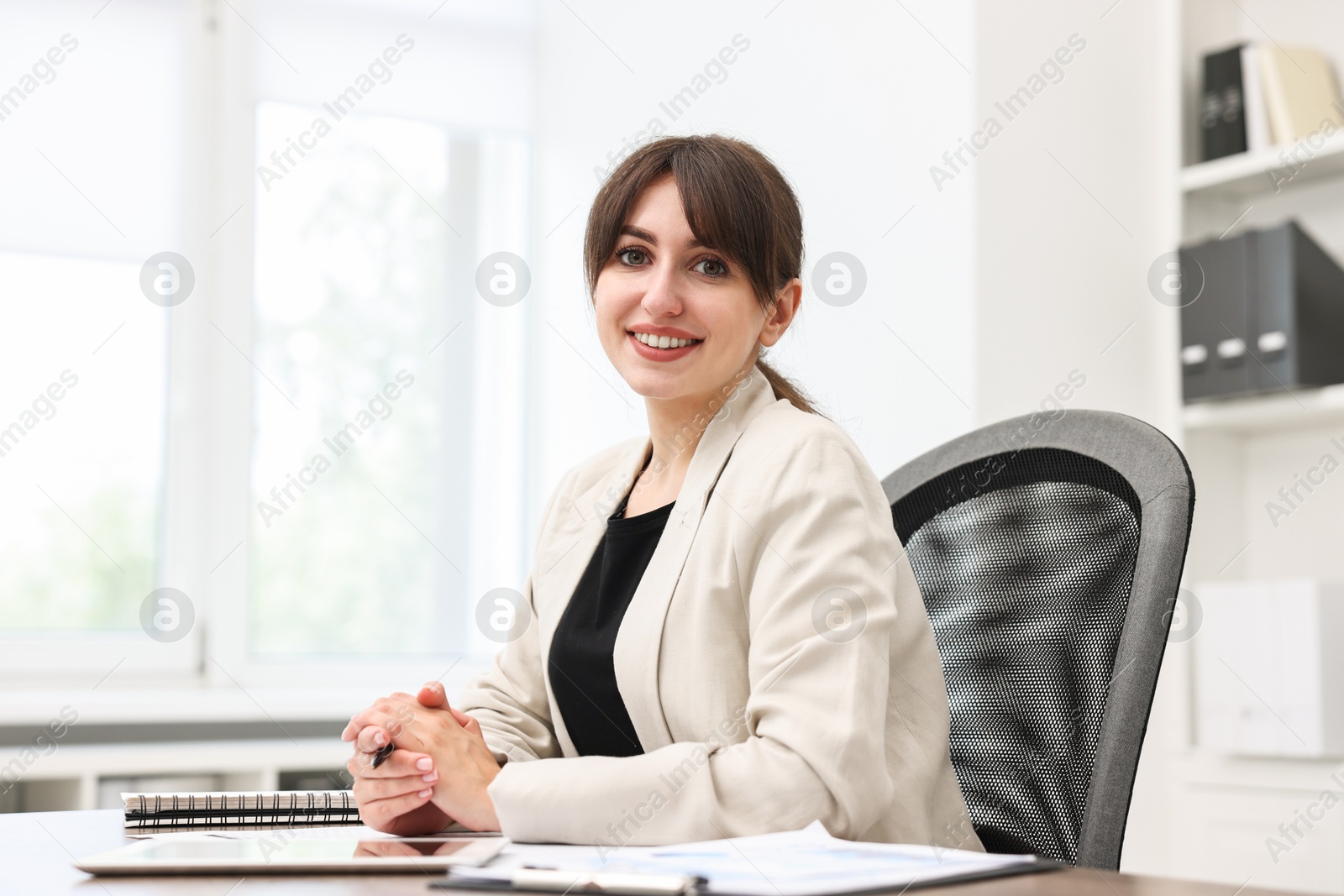 Photo of Portrait of smiling business consultant at table in office