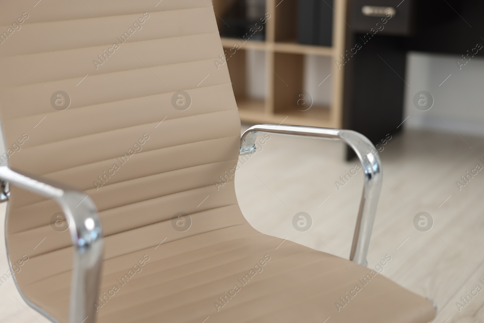 Photo of Stylish beige leather chair in office, closeup