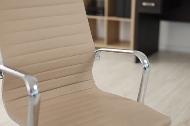 Photo of Stylish beige leather chair in office, closeup