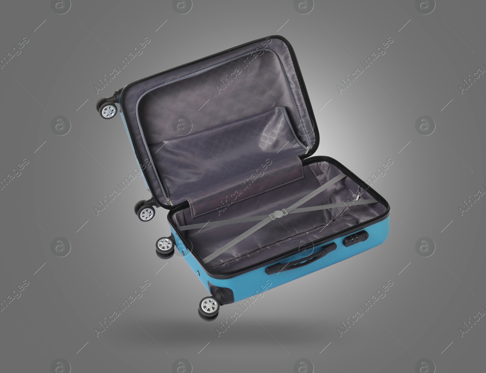 Image of Open empty suitcase in air on grey background