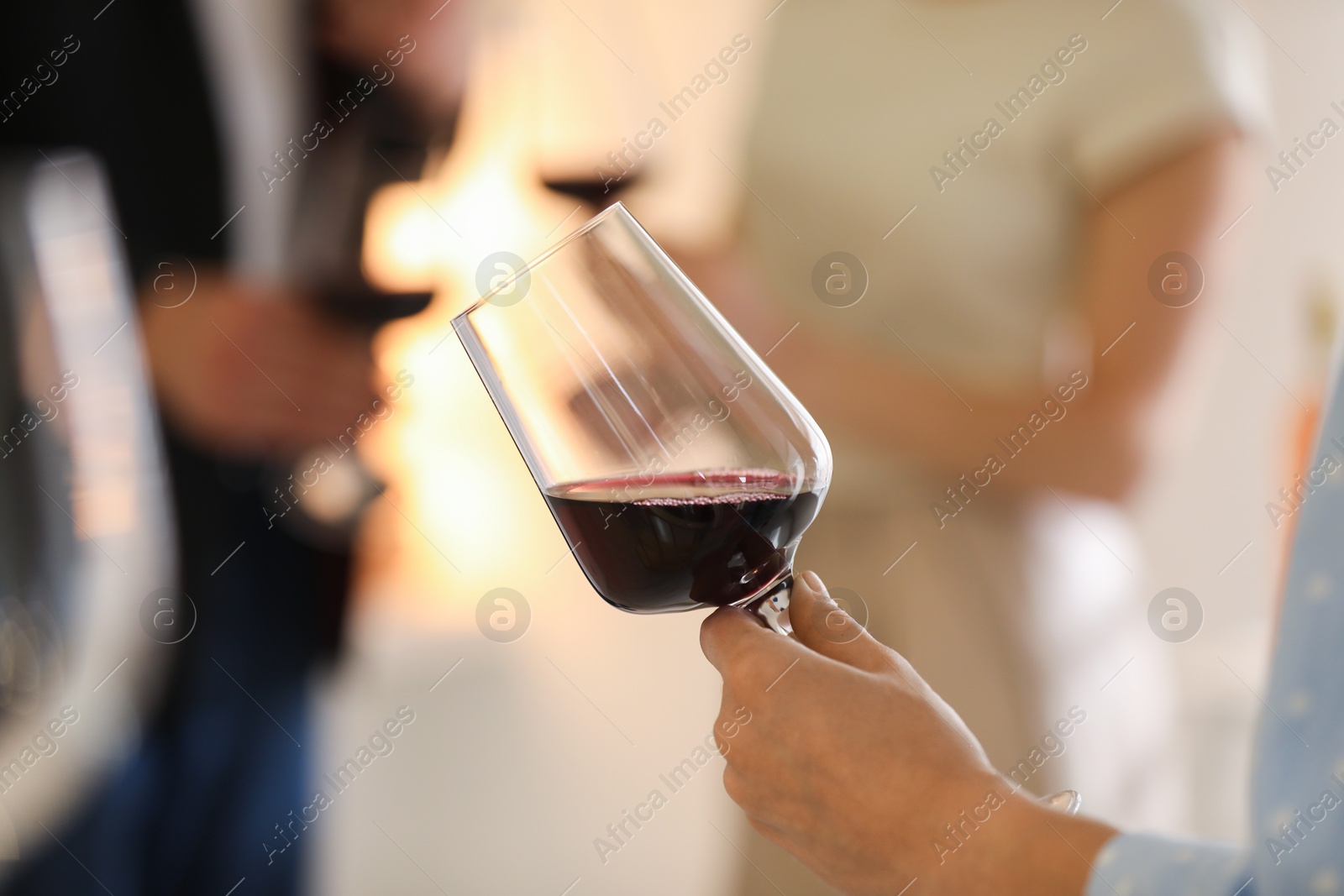 Photo of Woman with glass of red wine indoors, selective focus