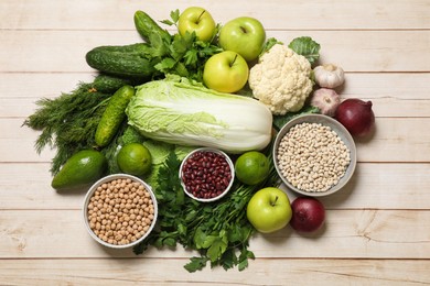 Photo of Different vegetarian products on light wooden table, top view