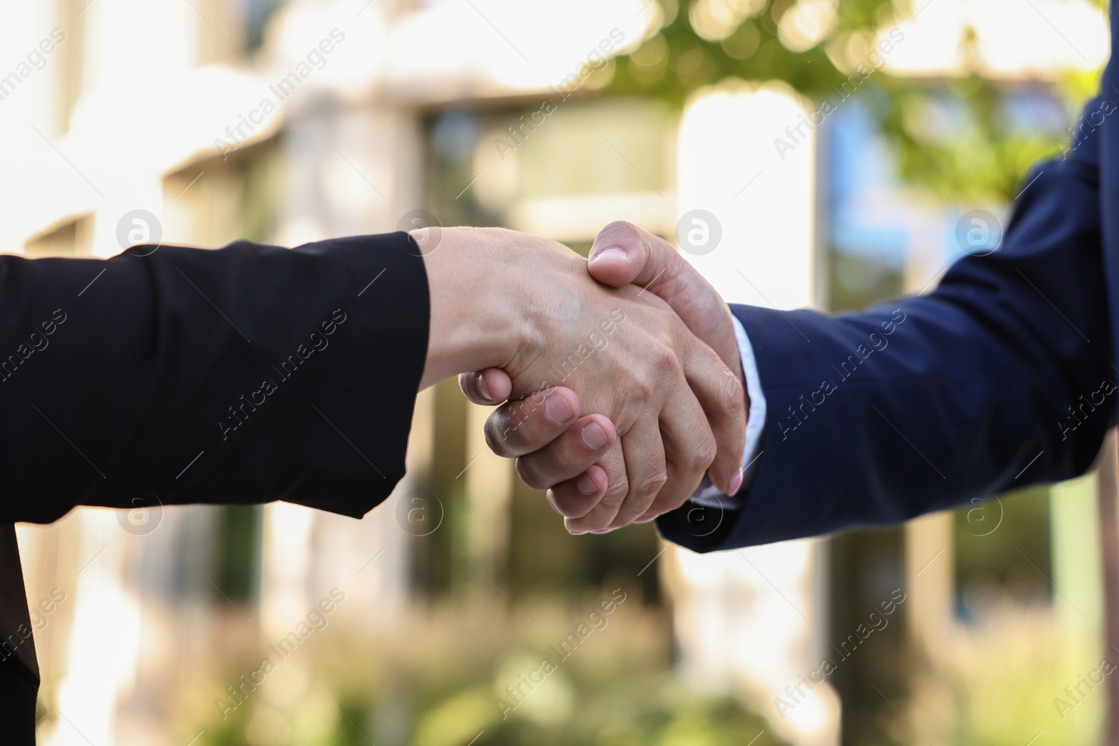 Photo of Diplomats shaking hands during meeting outdoors, closeup