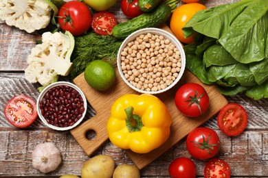 Photo of Different vegetarian products on wooden table, top view