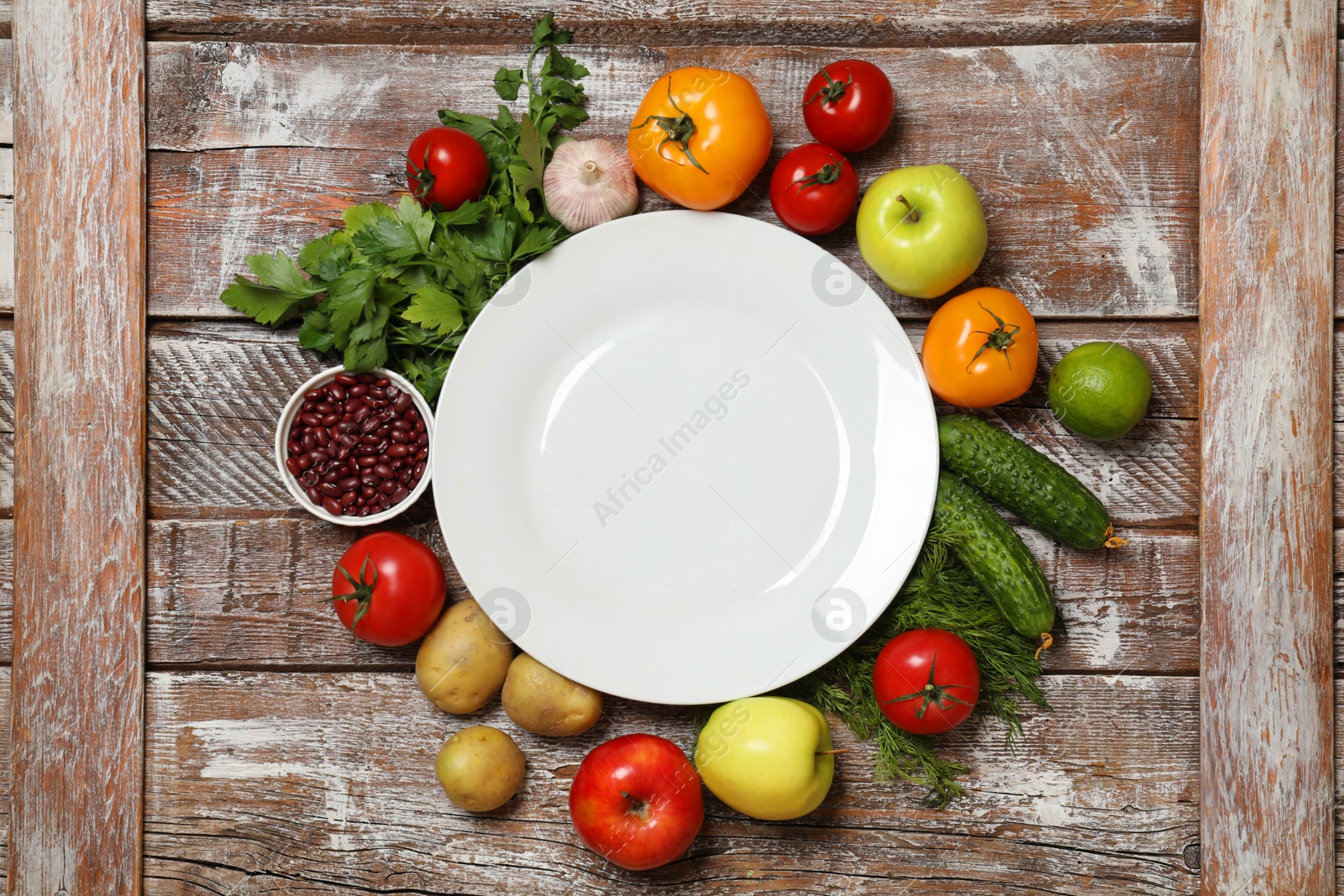 Photo of Different vegetarian products on wooden table, top view