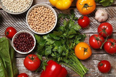 Photo of Different vegetarian products on wooden table, top view