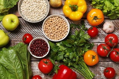 Different vegetarian products on wooden table, top view