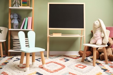 Photo of Stylish child room interior with different toys and furniture