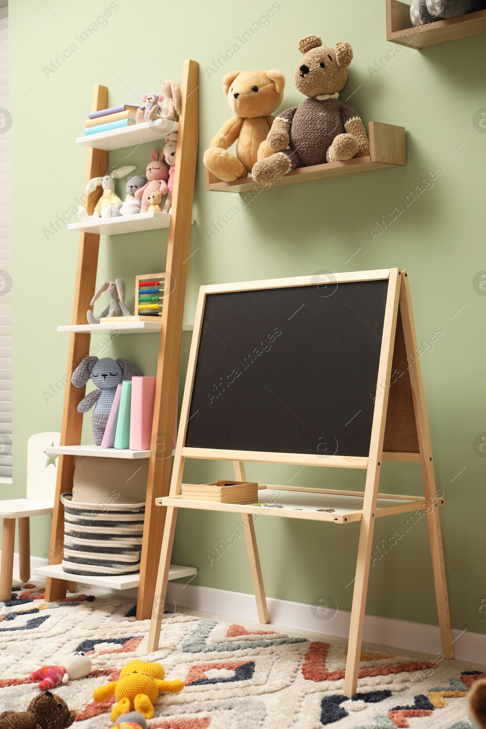 Photo of Stylish child room interior with different toys and furniture