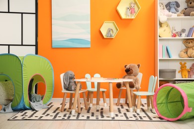 Photo of Stylish child room interior with different toys and furniture