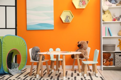 Stylish child room interior with different toys and furniture