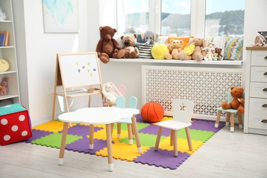 Photo of Stylish child room interior with different toys and furniture