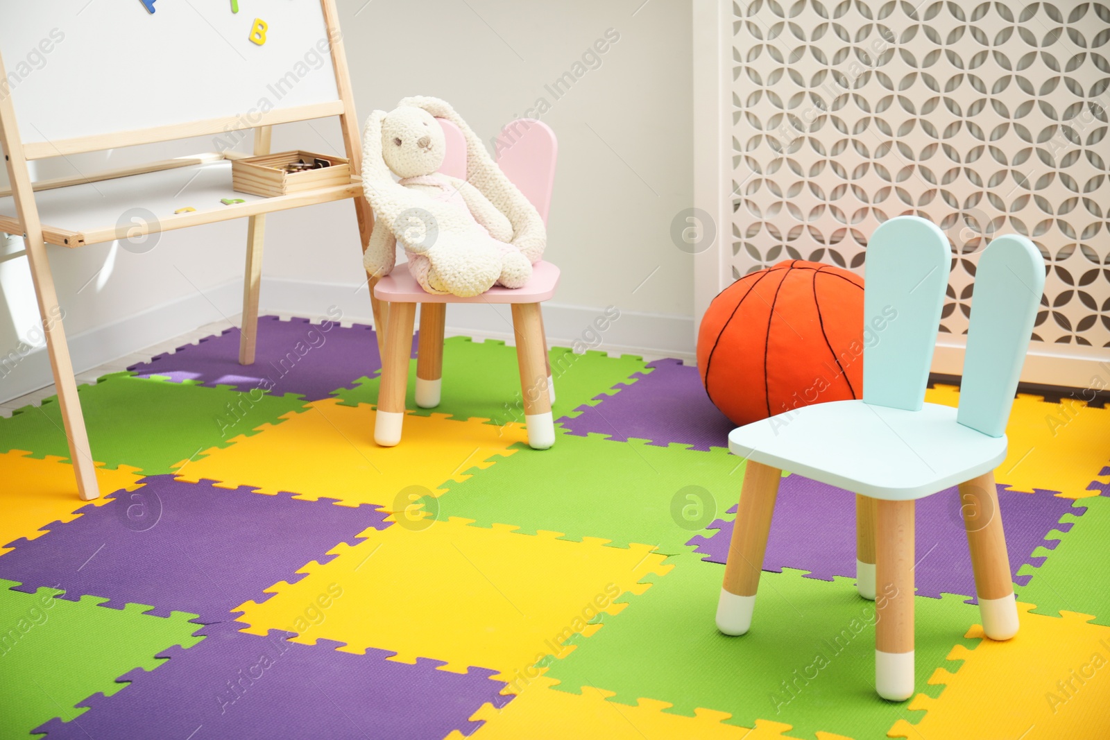 Photo of Stylish child room interior with different toys and furniture