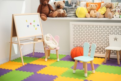 Photo of Stylish child room interior with different toys and furniture