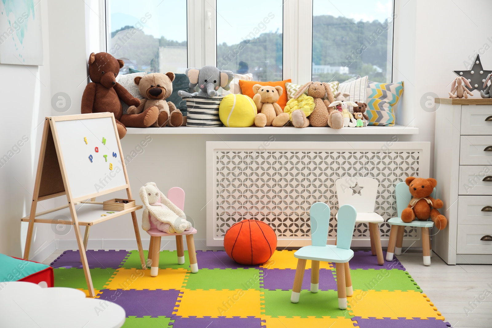 Photo of Stylish child room interior with different toys and furniture