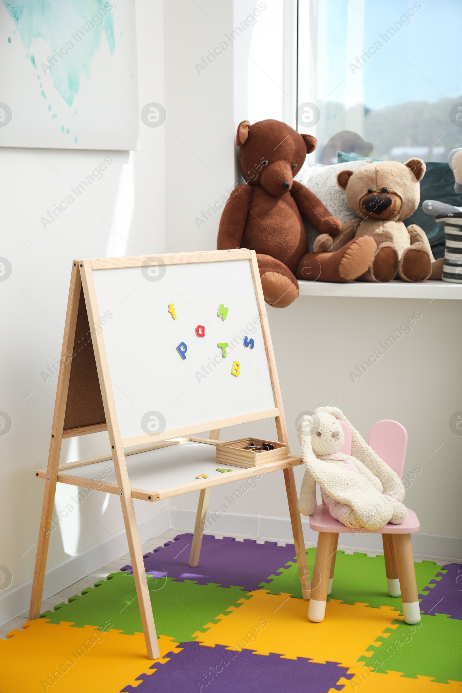 Photo of Stylish child room interior with different toys and furniture