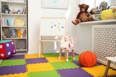 Stylish child room interior with different toys and furniture